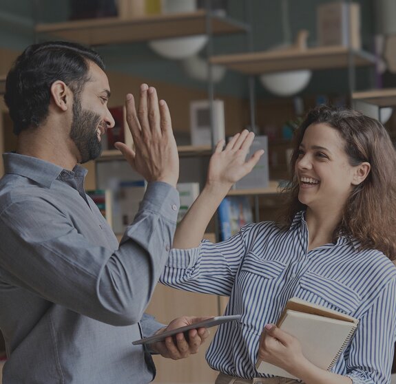 two colleagues high five it jobs timetoact group