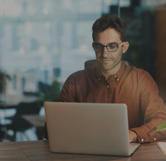 man working on notebook it jobs timetoact group