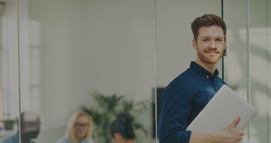 man with notebook in meeting room it jobs timetoact group