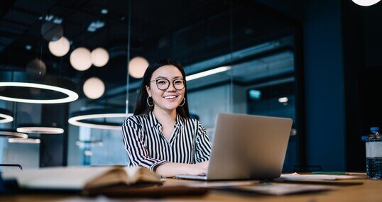 Happy woman working with laptop